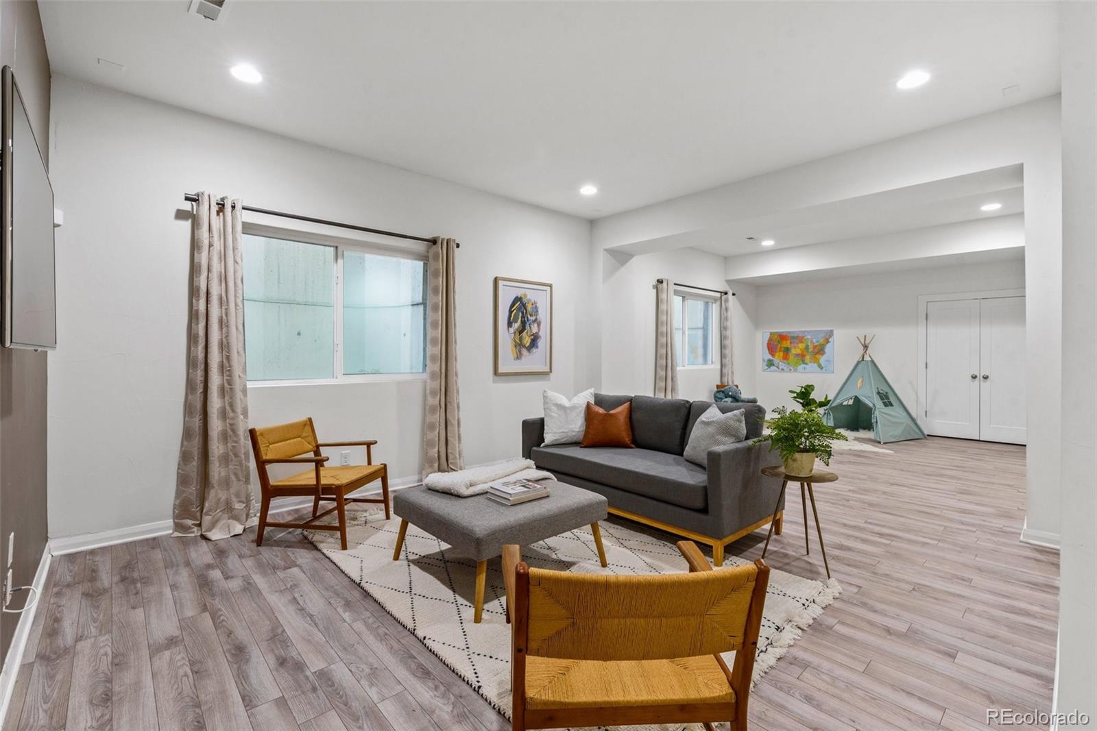6731 Raritan Drive Denver, CO 80221 - Photo 29 of 40 a living room with furniture and wooden floor