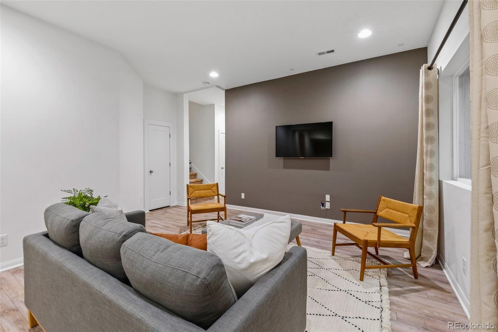 6731 Raritan Drive Denver, CO 80221 - Photo 30 of 40 a living room with furniture and a flat screen tv