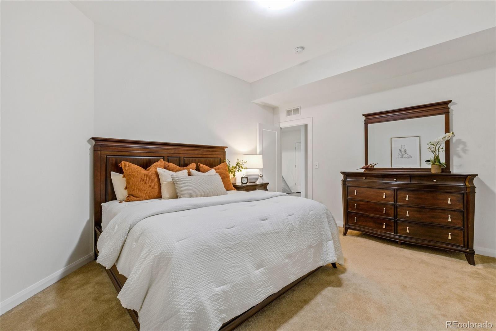 6731 Raritan Drive Denver, CO 80221 - Photo 31 of 40 a bedroom with a bed and a dresser