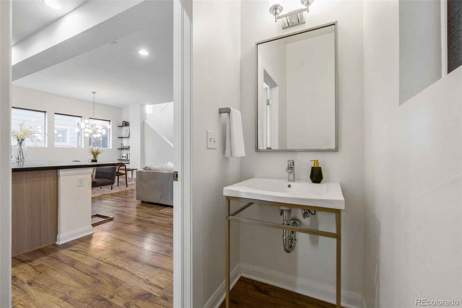 6731 Raritan Drive Denver, CO 80221 - Photo 34 of 40 a bathroom with a sink a toilet and mirror