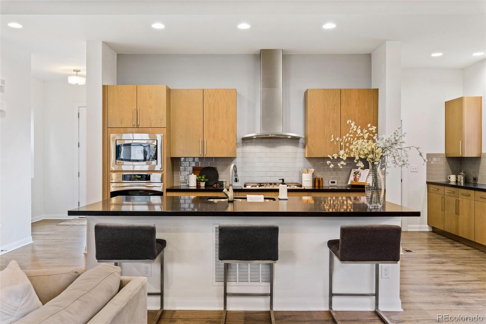 6731 Raritan Drive Denver, CO 80221 - Photo 5 of 40 a kitchen with granite countertop a stove a sink and a refrigerator