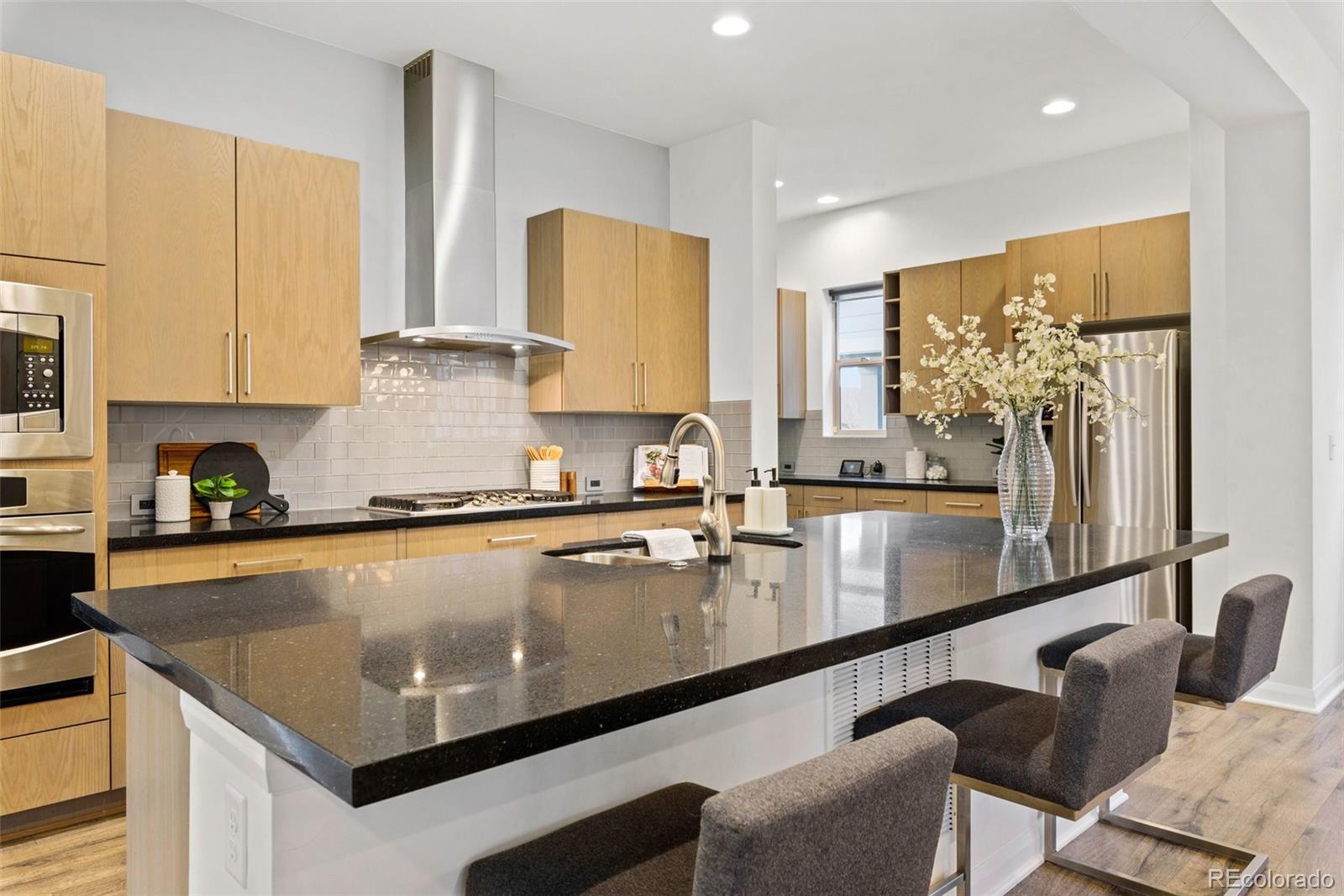6731 Raritan Drive Denver, CO 80221 - Photo 6 of 40 a kitchen with granite countertop a sink a counter top space cabinets and stainless steel appliances