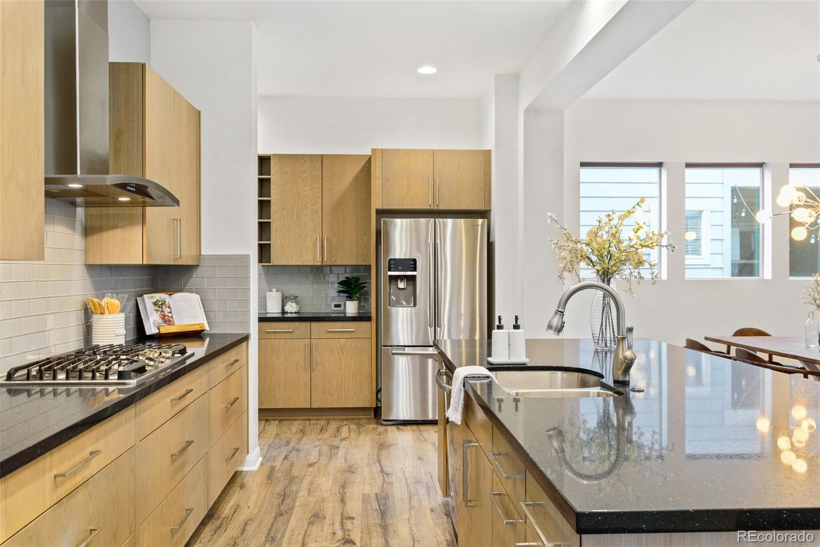 6731 Raritan Drive Denver, CO 80221 - Photo 7 of 40 a kitchen with kitchen island granite countertop a sink appliances cabinets and counter space