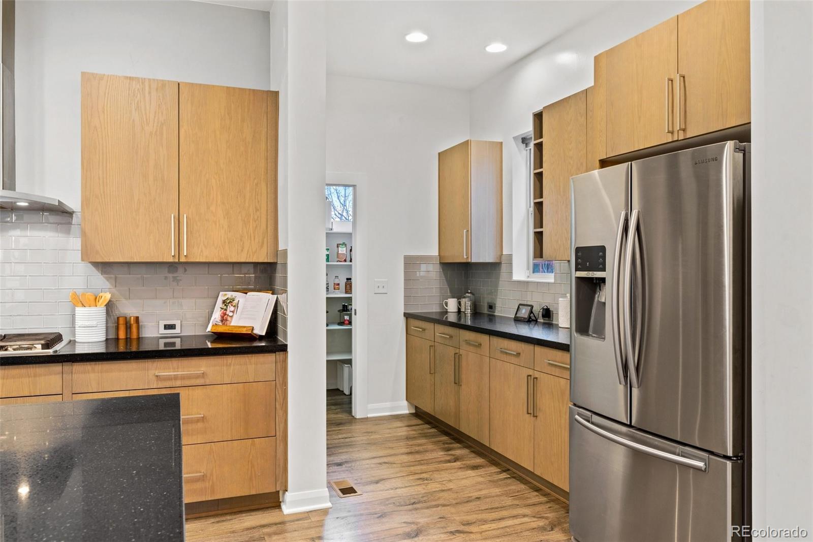 6731 Raritan Drive Denver, CO 80221 - Photo 8 of 40 a kitchen with stainless steel appliances a refrigerator sink and microwave