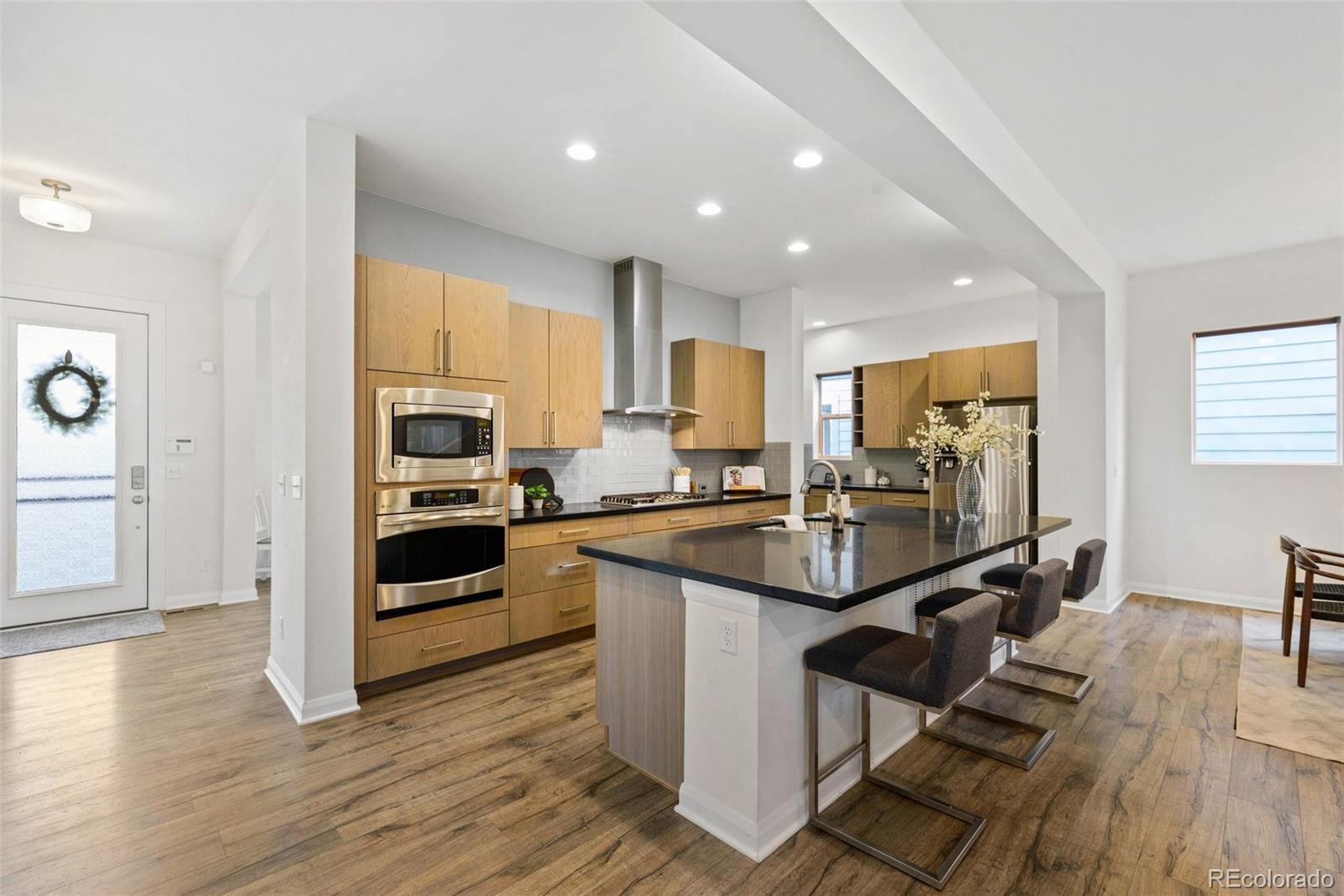6731 Raritan Drive Denver, CO 80221 - Photo 9 of 40 a kitchen with kitchen island granite countertop a sink appliances and cabinets