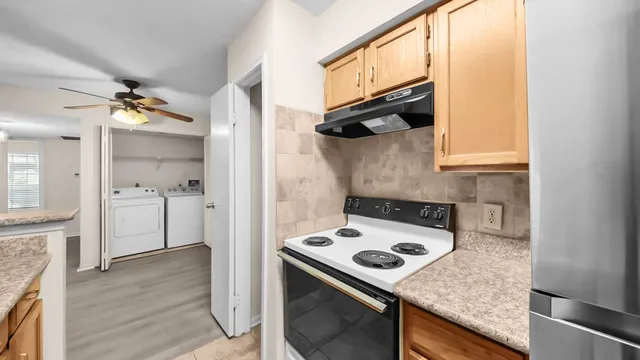 a view of a kitchen from the hallway