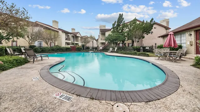 a view of a swimming pool with sitting area
