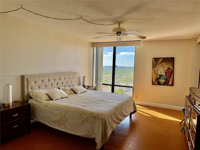a spacious bedroom with a bed and a chandelier