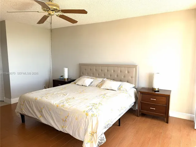 a bedroom with a bed and ceiling fan