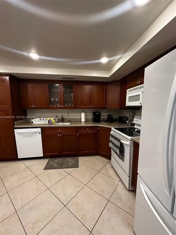 a kitchen with stainless steel appliances and cabinets
