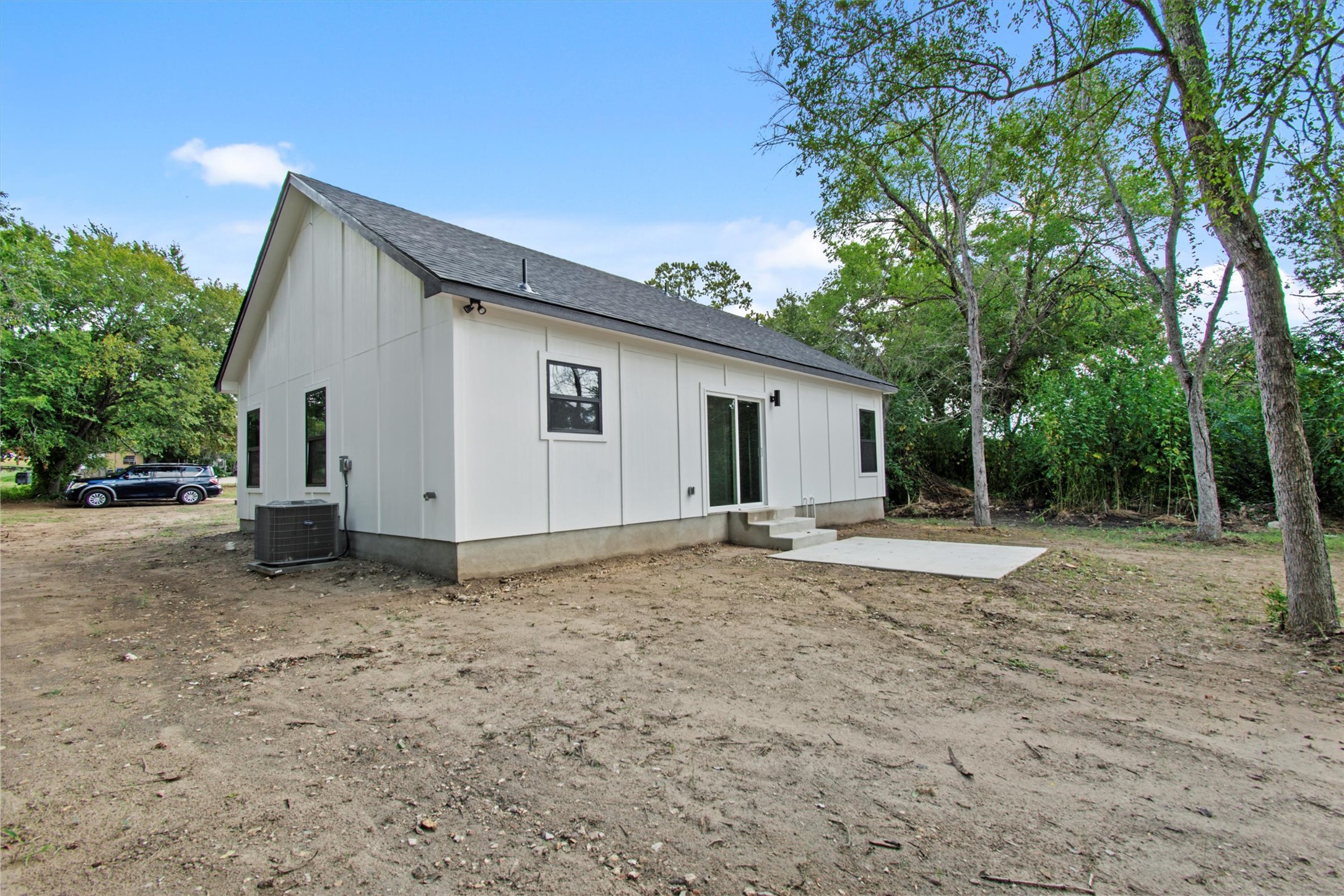 408 Griffin Street Luling, TX 78648 - Photo 30 of 34 Rear view of property featuring board and batten siding, roof with shingles, and entry steps