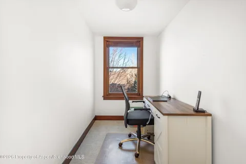 a workspace with furniture and window