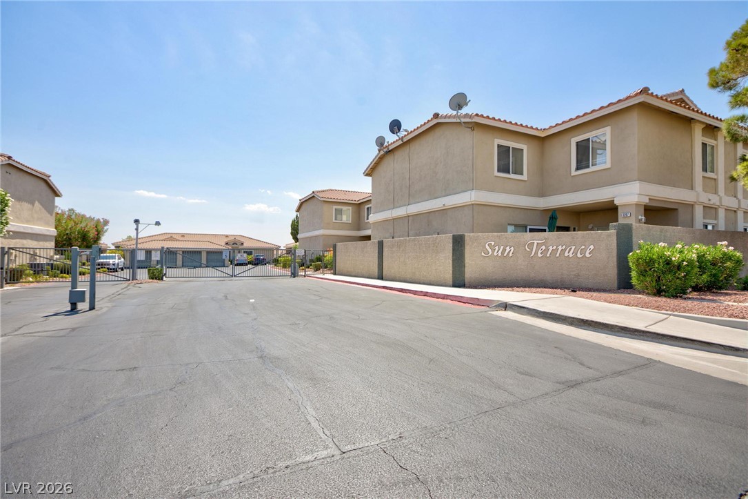 3238 Mystic Ridge Court Las Vegas, NV 89129 - Photo 25 of 31 Secure community entrance with an inviting facade, featuring the "Sun Terrace" monument sign.