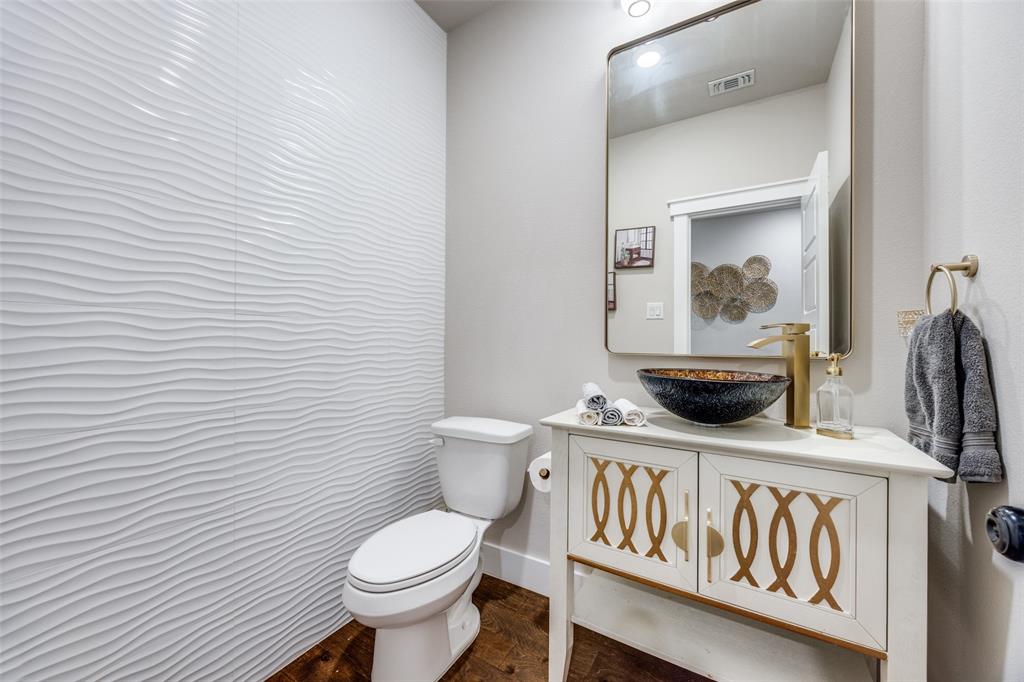 9425 Dripping Springs Road Denison, TX 75021 - Photo 11 of 39 a white toilet sitting next to a bathroom sink