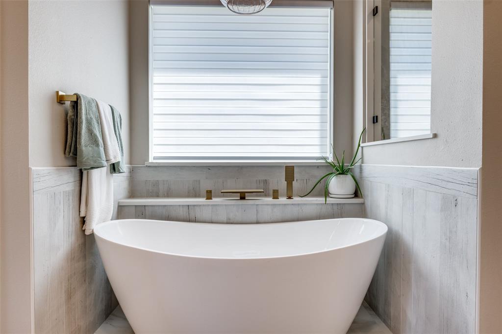 9425 Dripping Springs Road Denison, TX 75021 - Photo 17 of 39 a white bath tub sitting in a bathroom