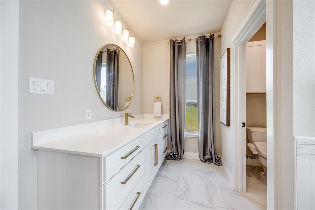 9425 Dripping Springs Road Denison, TX 75021 - Photo 18 of 39 a bathroom with a double vanity sink mirror and bathtub