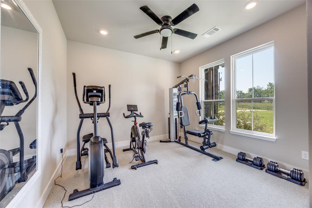 9425 Dripping Springs Road Denison, TX 75021 - Photo 22 of 39 a view of a room with gym equipment