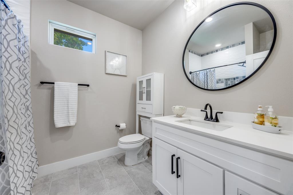 9425 Dripping Springs Road Denison, TX 75021 - Photo 26 of 39 a bathroom with a granite countertop sink and a mirror