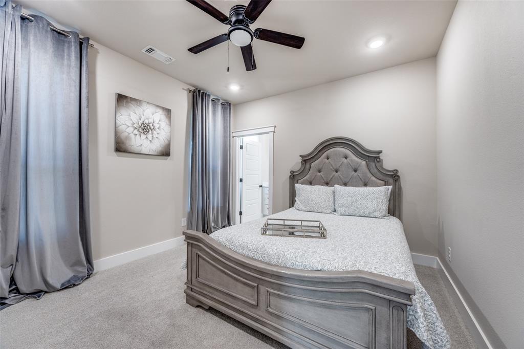 9425 Dripping Springs Road Denison, TX 75021 - Photo 27 of 39 a bedroom with a bed and ceiling fan