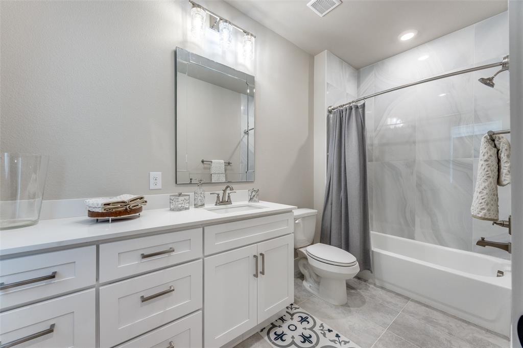 9425 Dripping Springs Road Denison, TX 75021 - Photo 29 of 39 a bathroom with a sink a toilet and a large mirror
