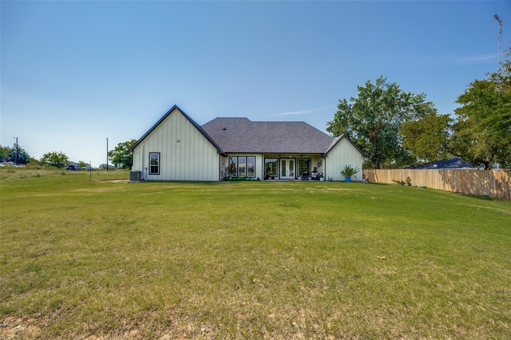 9425 Dripping Springs Road Denison, TX 75021 - Photo 35 of 39 a view of a house with yard and deck