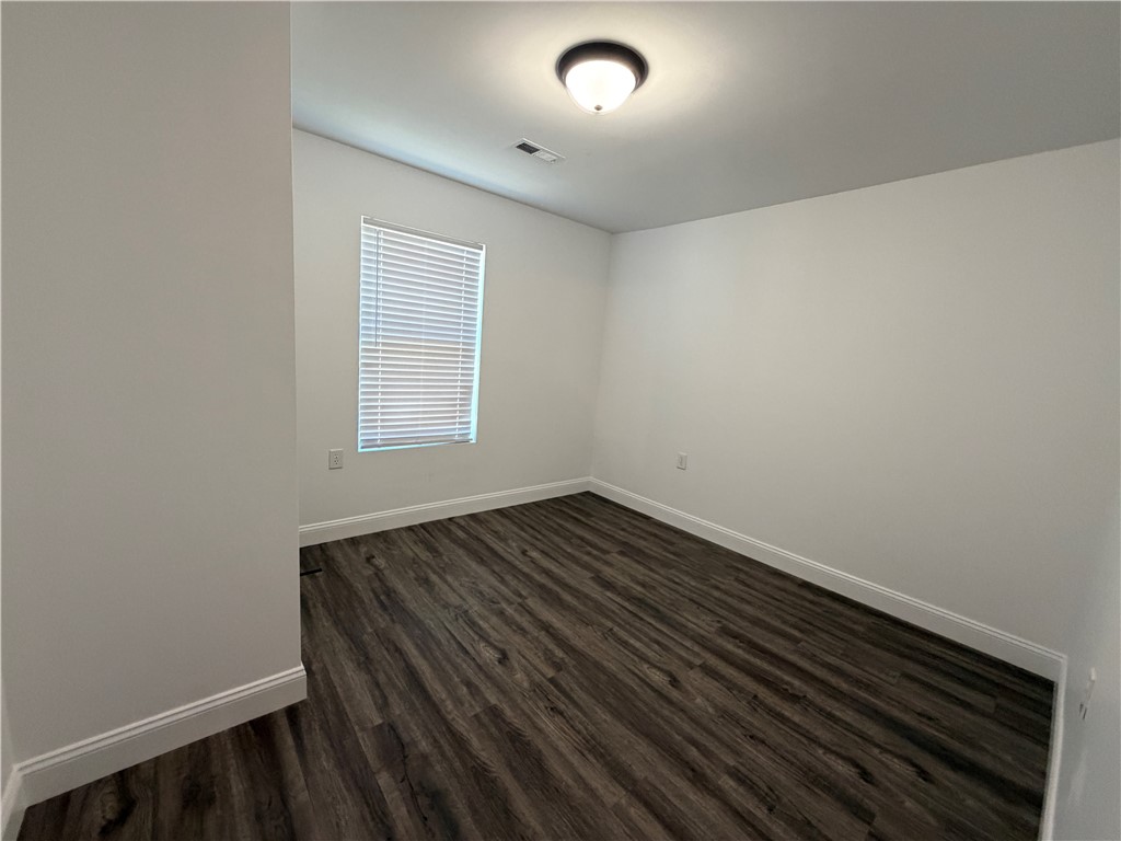 2910 Chambers Road Anderson, SC 29626 - Photo 10 of 16 Rich dark wood flooring complements crisp neutral walls and a clean architectural design.