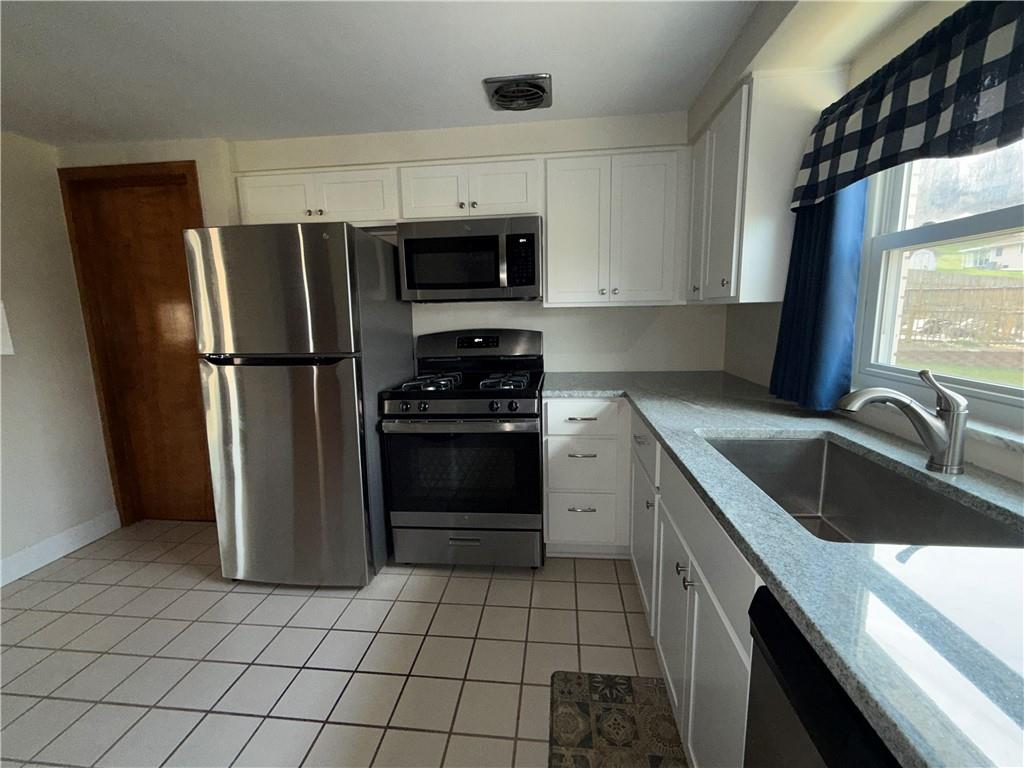 151 Thorne Road Washington, PA 15301 - Photo 5 of 23 a kitchen with a refrigerator sink and stove