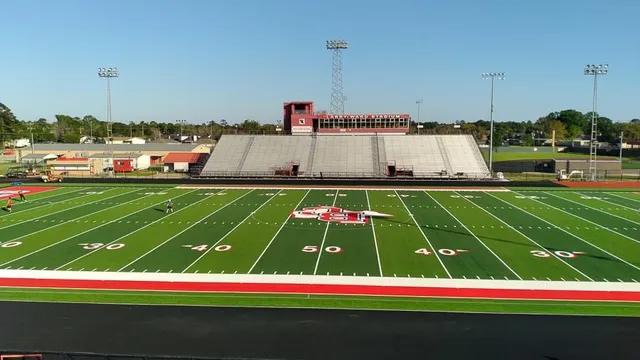 a white and green field with lots of trees in it