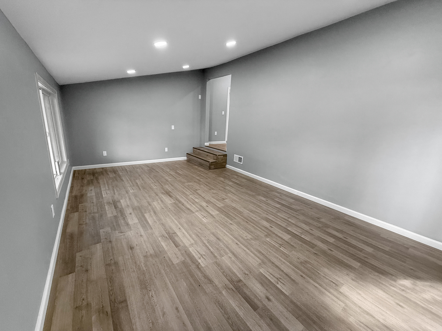302 West Cook Street Sheffield, IL 61361 - Photo 10 of 18 a view of an empty room with wooden floor and a window