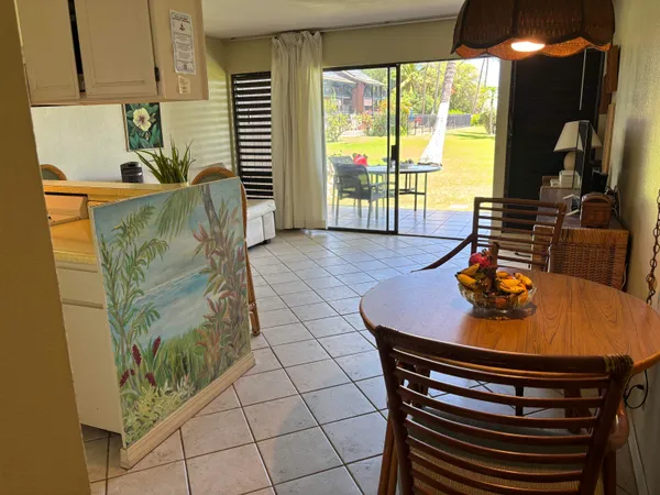 a view of a dining room with furniture and a floor to ceiling window