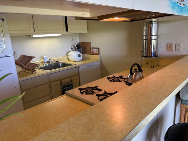 a kitchen with a sink stove and cabinets