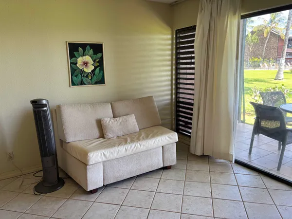 a living room with furniture and a floor to ceiling window