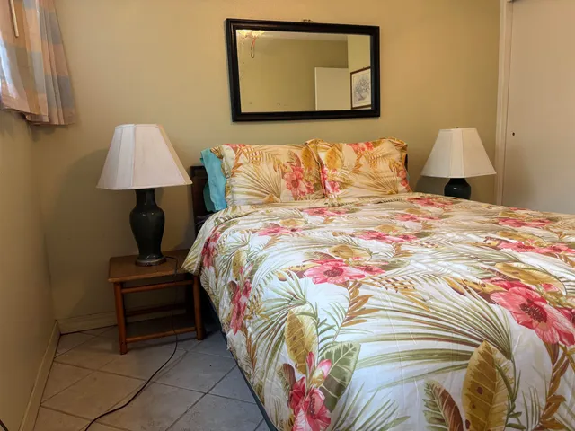 a bedroom with a bed and a lamp