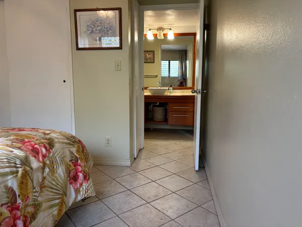 a bedroom with a bed and a mirror