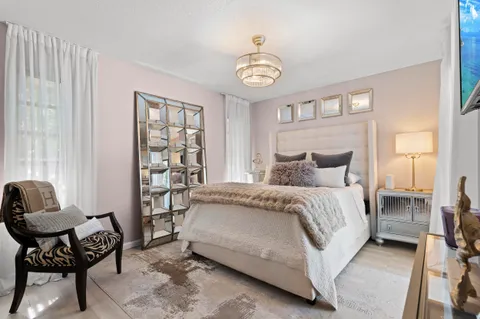 a bedroom with a bed and a chair