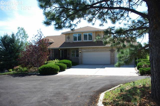 915 Forest View Road Monument, CO 80132 - Photo 2 of 35 mature landscaping at the front of the house is ready for you to enjoy!