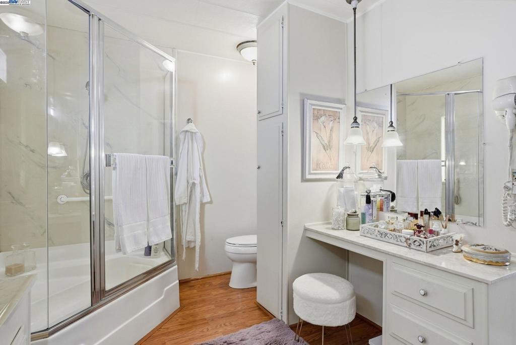 4141 Deep Creek Road Fremont, CA 94555 - Photo 32 of 54 a bathroom with a granite countertop sink toilet a mirror and shower