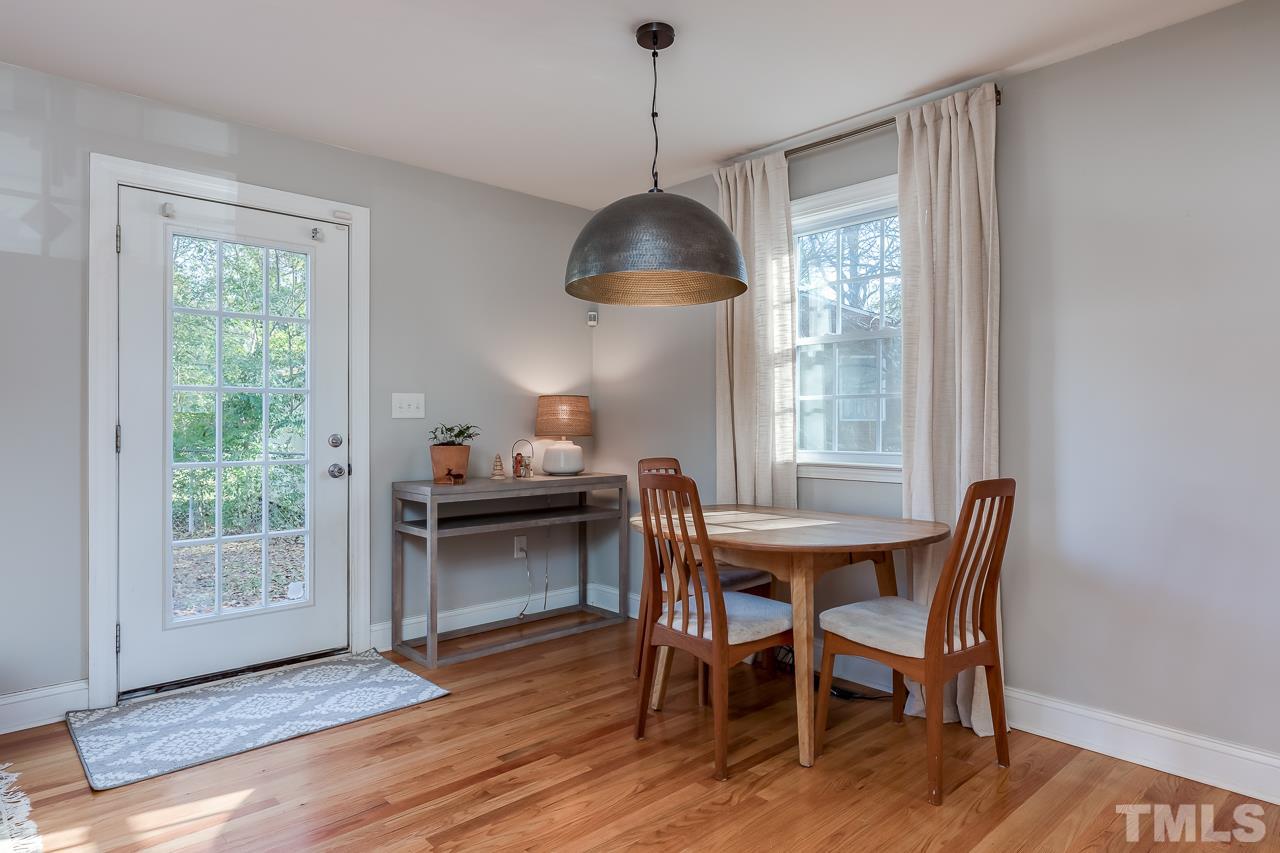 2411 Boswell Road Raleigh, NC 27610 - Photo 11 of 26 a dining room with furniture window and wooden floor