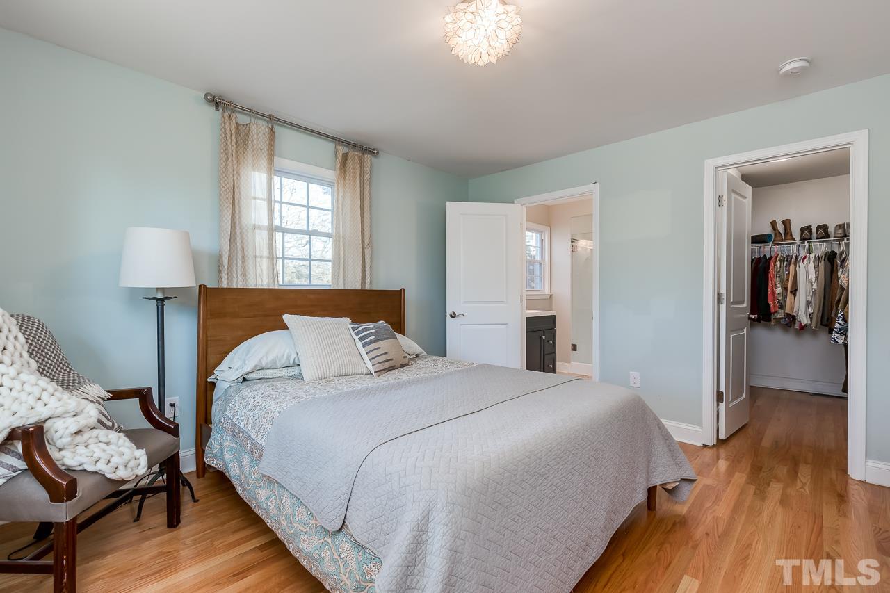 2411 Boswell Road Raleigh, NC 27610 - Photo 15 of 26 a bedroom with a bed and wooden floor