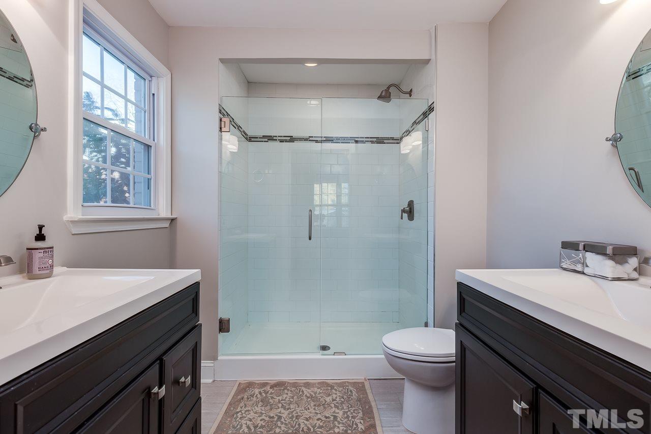 2411 Boswell Road Raleigh, NC 27610 - Photo 16 of 26 a bathroom with a sink toilet vanity and shower