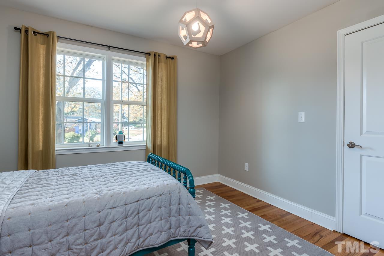 2411 Boswell Road Raleigh, NC 27610 - Photo 20 of 26 a bedroom with a bed and a window