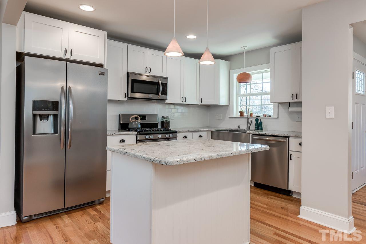 2411 Boswell Road Raleigh, NC 27610 - Photo 8 of 26 a kitchen with stainless steel appliances granite countertop a refrigerator a sink a stove a microwave and wooden floor