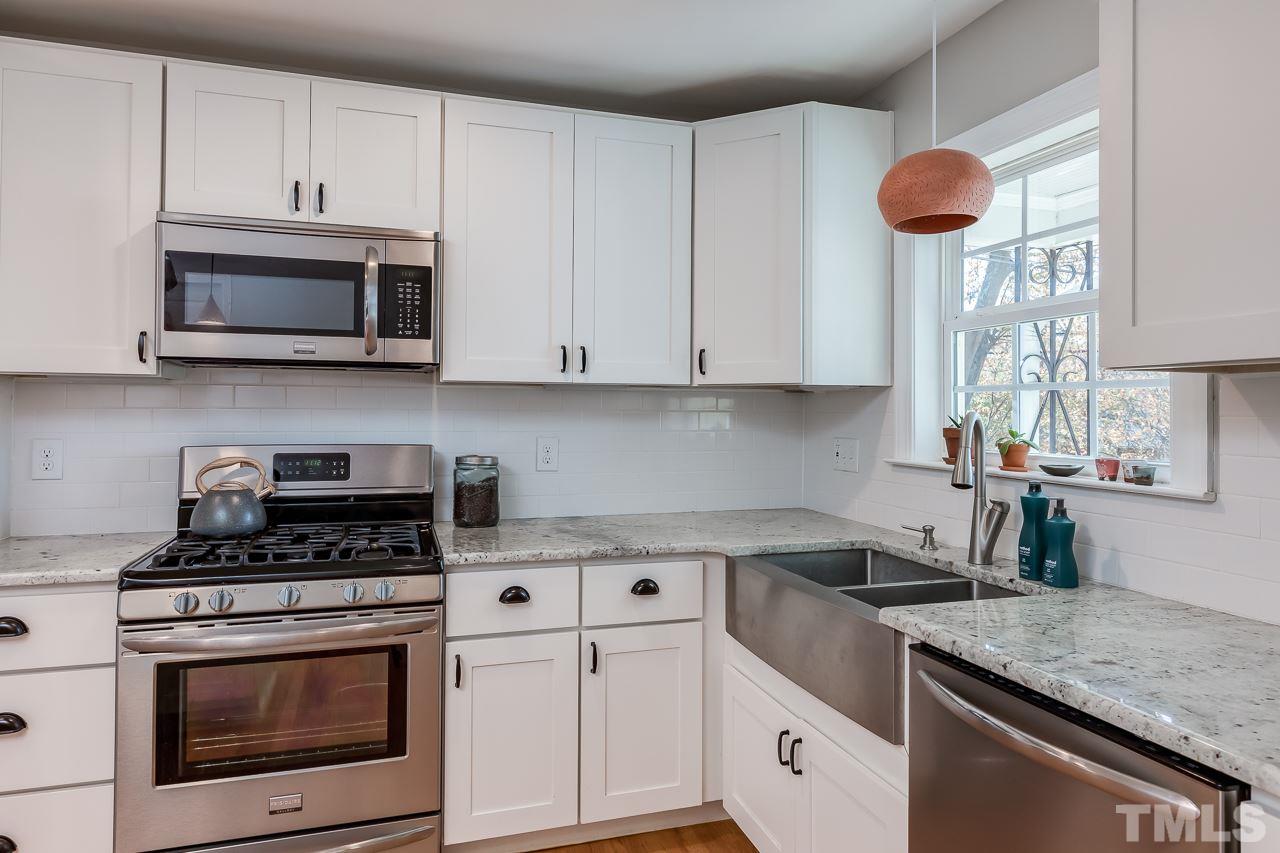 2411 Boswell Road Raleigh, NC 27610 - Photo 9 of 26 a kitchen with stainless steel appliances granite countertop a stove a sink and a microwave