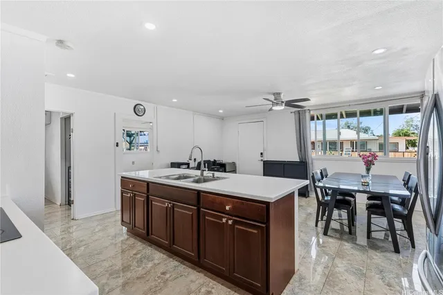 a large kitchen with a table and chairs