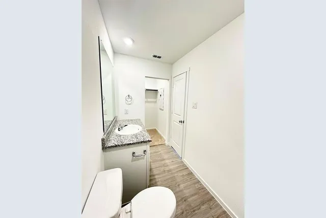 a bathroom with a granite countertop sink mirror vanity