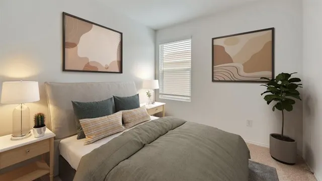 a bedroom with a bed and a painting on the wall