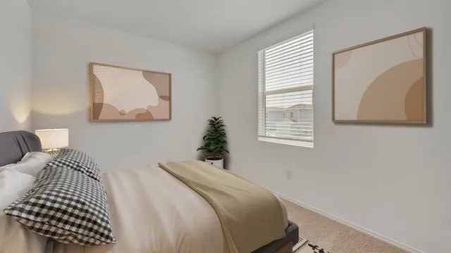 a bedroom with a bed and a painting on the wall