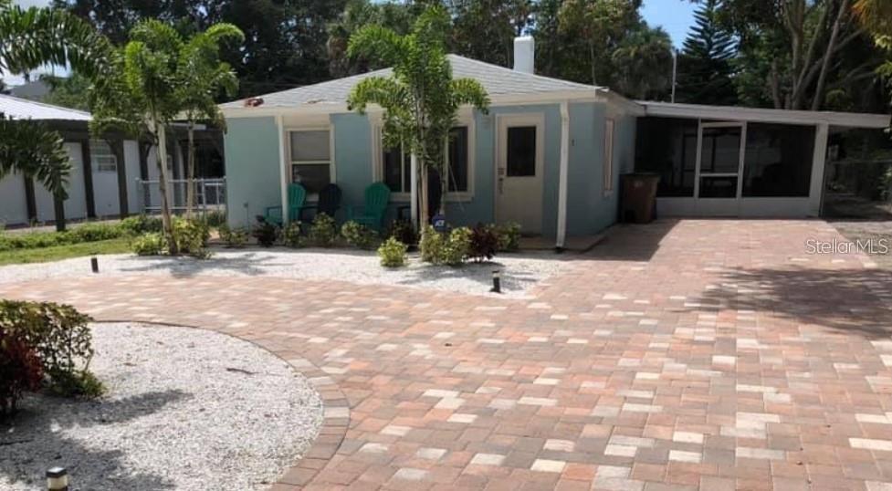 111 12th Avenue Indian Rocks Beach, FL 33785 - Photo 1 of 1 a view of a white house with a yard