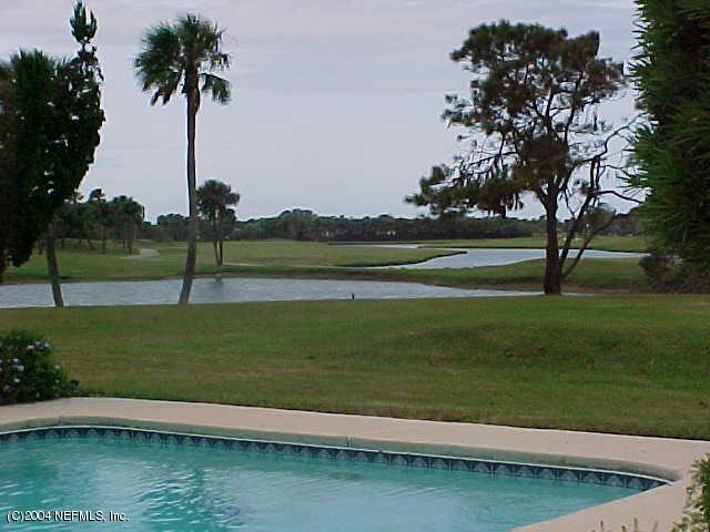 325 Pablo Road Ponte Vedra Beach, FL 32082 - Photo 3 of 3 a view of a lake with a yard and palm trees