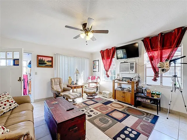 a living room with lots of furniture and a chandelier